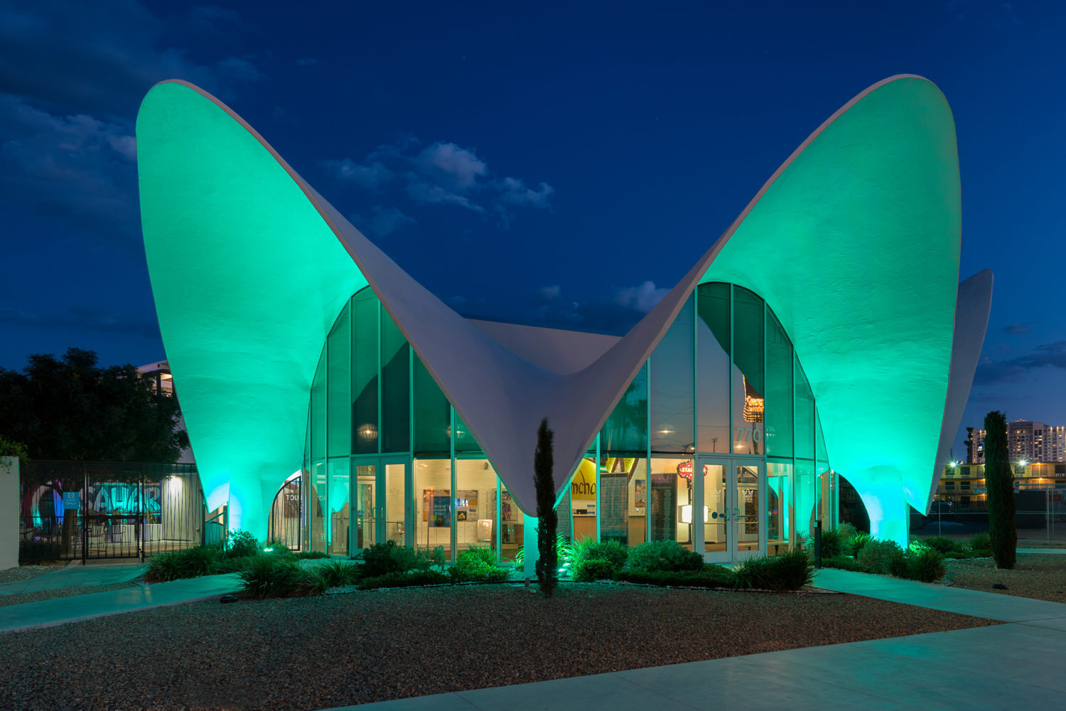 Neon Museum illuminated in green lights at night on Las Vegas Boulevard in Las Vegas // Getty Images